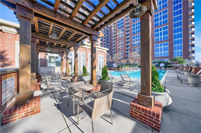 view of patio / terrace with a community pool and a pergola