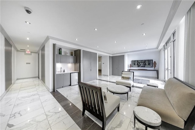 living room featuring crown molding, marble finish floor, baseboards, and recessed lighting