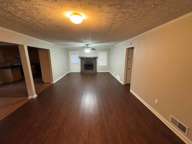 unfurnished living room with ceiling fan, ornamental molding, dark hardwood / wood-style floors, and a textured ceiling