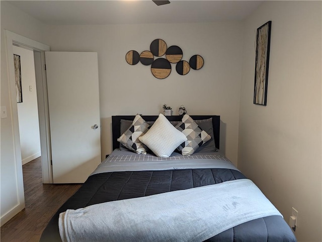 bedroom featuring dark wood finished floors and baseboards