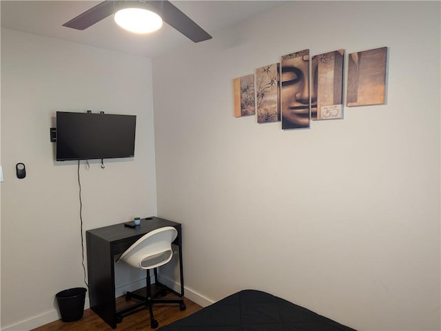 bedroom with dark wood-type flooring, ceiling fan, and baseboards