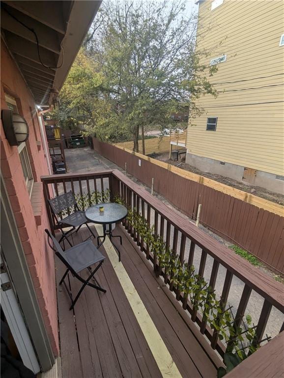 wooden deck with a fenced backyard