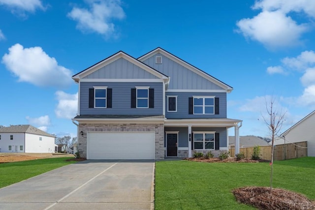 craftsman house with a front lawn and a garage