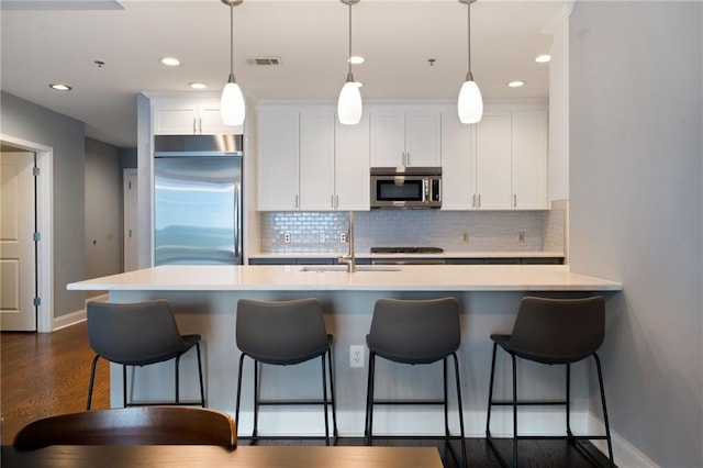 270 17th St NW Unit 2210, Atlanta, GA 30363 - kitchen with stainless steel appliances, baseboards, white cabinets, decorative backsplash, and recessed lighting