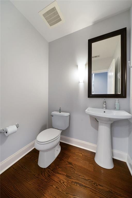 270 17th St NW Unit 2210, Atlanta, GA 30363 - bathroom featuring baseboards, toilet, and wood finished floors