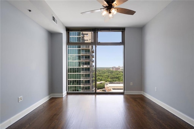 270 17th St NW Unit 2210, Atlanta, GA 30363 - empty room with floor to ceiling windows, wood finished floors, ceiling fan, and baseboards