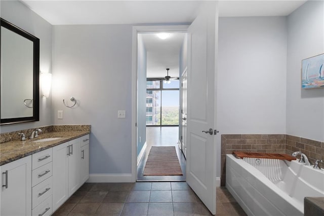 270 17th St NW Unit 2210, Atlanta, GA 30363 - bathroom featuring vanity, a bath, tile patterned floors, baseboards, and a ceiling fan