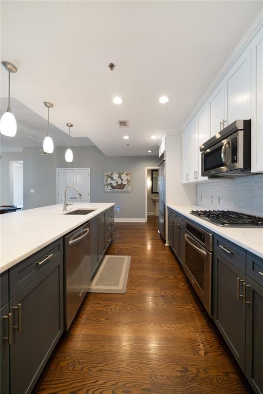 270 17th St NW Unit 2210, Atlanta, GA 30363 - kitchen with stainless steel appliances, a sink, baseboards, white cabinetry, and recessed lighting