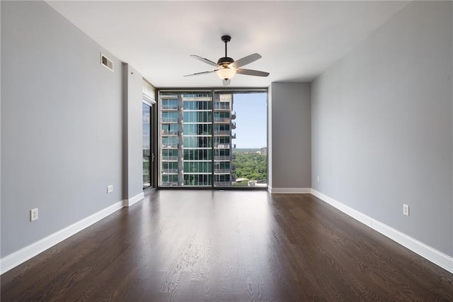 270 17th St NW Unit 2210, Atlanta, GA 30363 - spare room featuring floor to ceiling windows, wood finished floors, ceiling fan, and baseboards