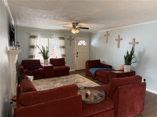 living room with ornamental molding, dark hardwood / wood-style flooring, and a textured ceiling