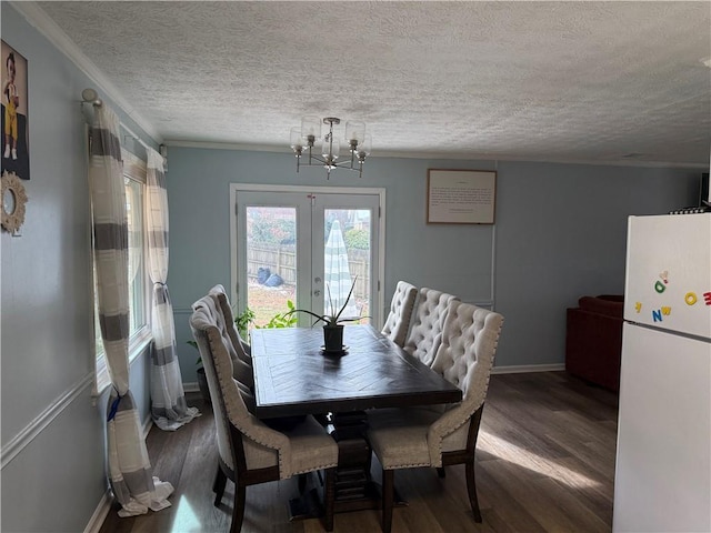 dining room with hardwood / wood-style flooring, a textured ceiling, and french doors