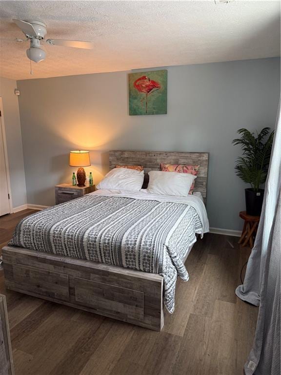 bedroom featuring dark hardwood / wood-style floors and ceiling fan