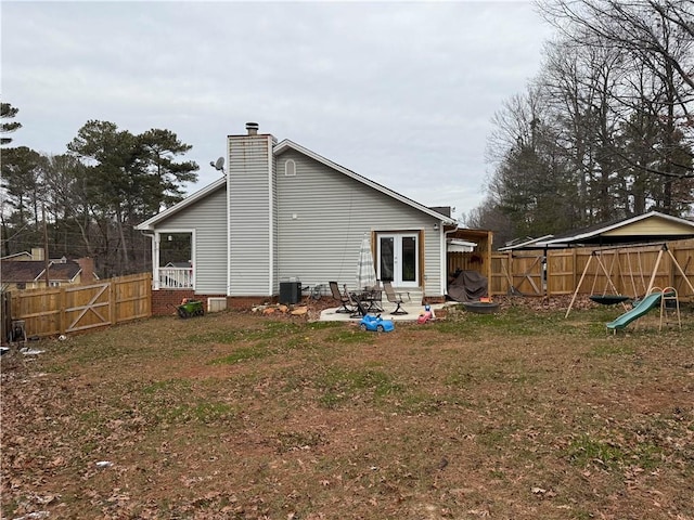 back of house with a patio, a yard, cooling unit, and french doors