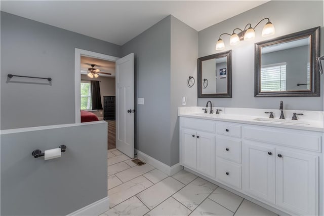 250 Silas Rd, Dahlonega, GA 30533 - bathroom featuring marble look tile flooring, ensuite bath, double vanity, ceiling fan, and baseboards