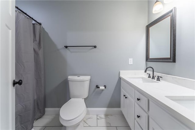 250 Silas Rd, Dahlonega, GA 30533 - bathroom featuring toilet, double vanity, marble finish flooring, and baseboards