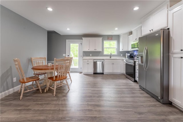 250 Silas Rd, Dahlonega, GA 30533 - kitchen with appliances with stainless steel finishes, white cabinets, a sink, dark wood-style floors, and light countertops