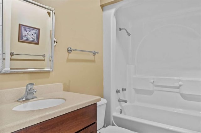 full bathroom featuring shower / bathing tub combination, vanity, and toilet