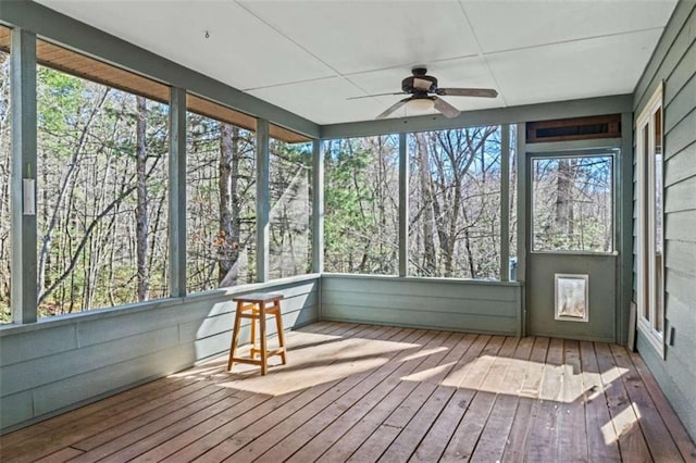 unfurnished sunroom with a wealth of natural light and a ceiling fan