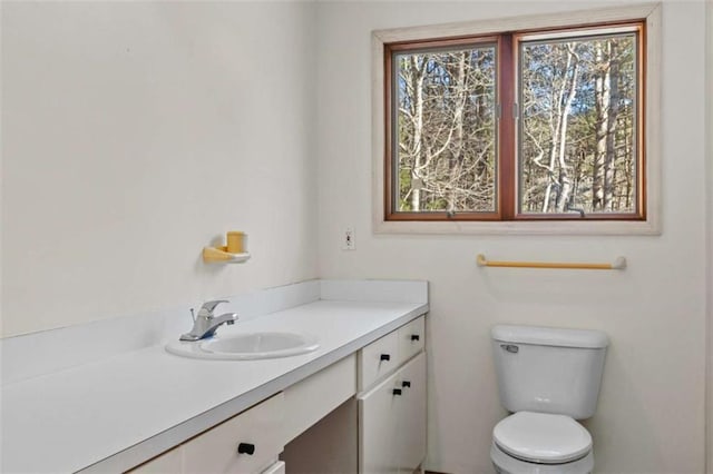 bathroom with toilet and vanity