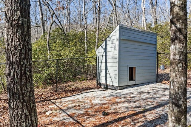 view of shed featuring fence