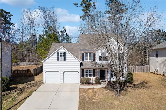 view of front of property with a garage, concrete driveway, fence, a front yard, and brick siding