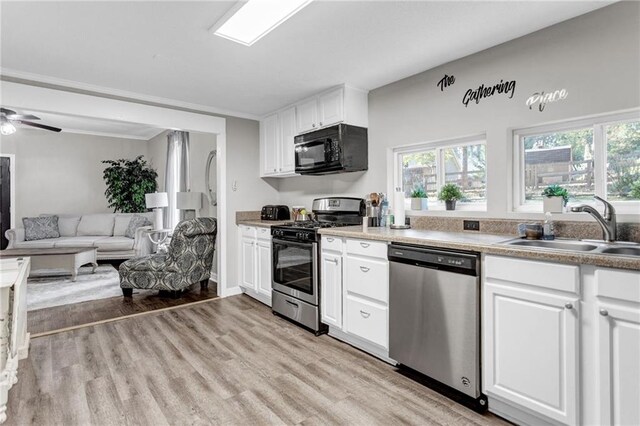 4481 Mclain Cir, Acworth, GA 30101 - kitchen with a sink, light wood-style floors, appliances with stainless steel finishes, and a wealth of natural light