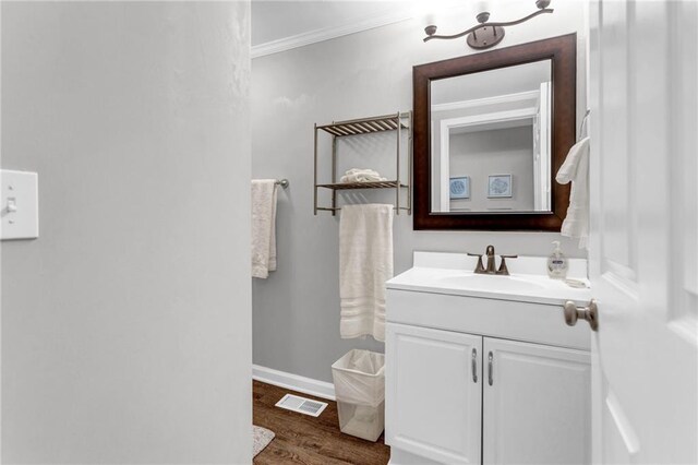 4481 Mclain Cir, Acworth, GA 30101 - bathroom featuring visible vents, baseboards, ornamental molding, wood finished floors, and vanity