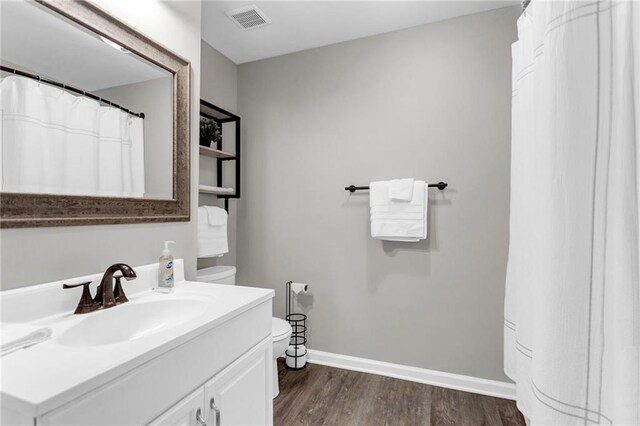 4481 Mclain Cir, Acworth, GA 30101 - bathroom featuring vanity, wood finished floors, visible vents, baseboards, and toilet