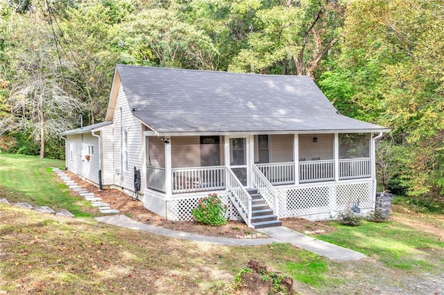 4481 Mclain Cir, Acworth, GA 30101 - view of front facade featuring a wooded view, a front lawn, and a sunroom