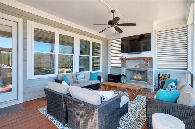 exterior space with an outdoor living space with a fireplace and a ceiling fan