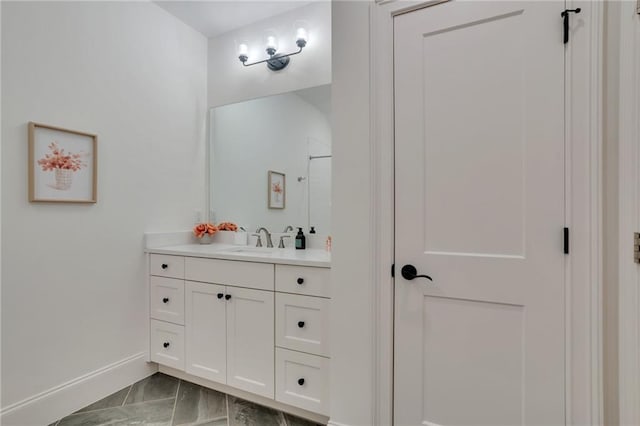 full bathroom featuring vanity, baseboards, marble finish floor, and a shower