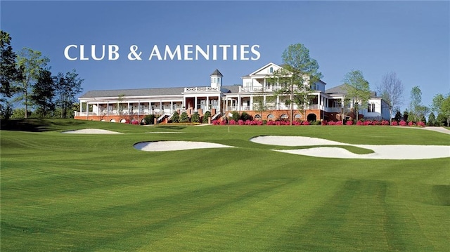 view of property's community with golf course view and a yard