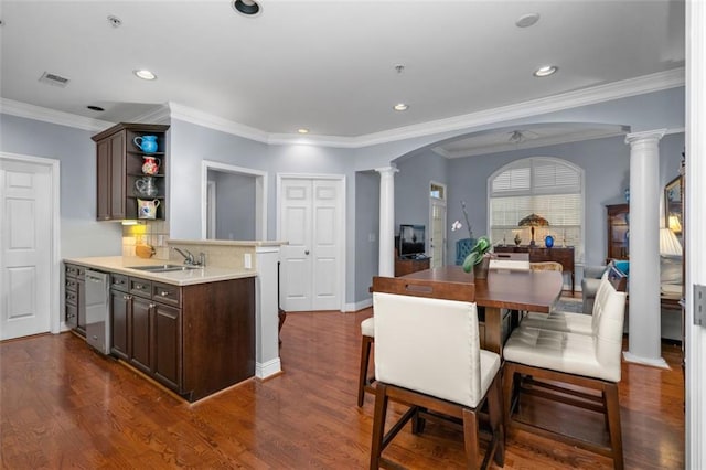 kitchen with ornamental molding, sink, dark hardwood / wood-style floors, and decorative columns