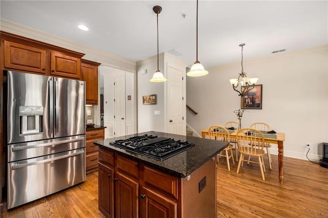11271 Calypso Dr, Alpharetta, GA 30009 - kitchen with stainless steel fridge, black gas cooktop, light wood-style floors, a center island, and ornamental molding