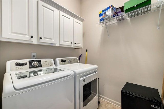 11271 Calypso Dr, Alpharetta, GA 30009 - laundry room featuring independent washer and dryer, cabinet space, and light tile patterned floors