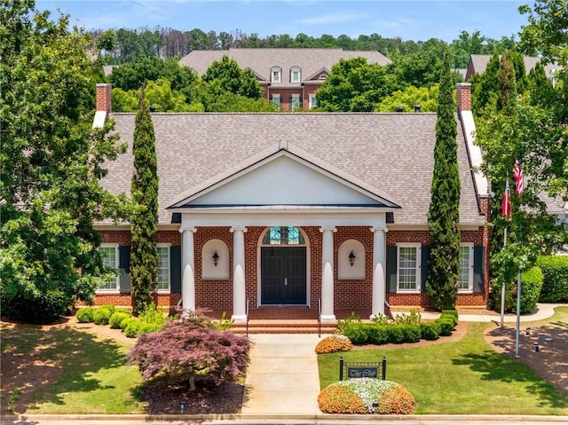 11271 Calypso Dr, Alpharetta, GA 30009 - greek revival inspired property with a chimney, brick siding, a front yard, a shingled roof, and a porch