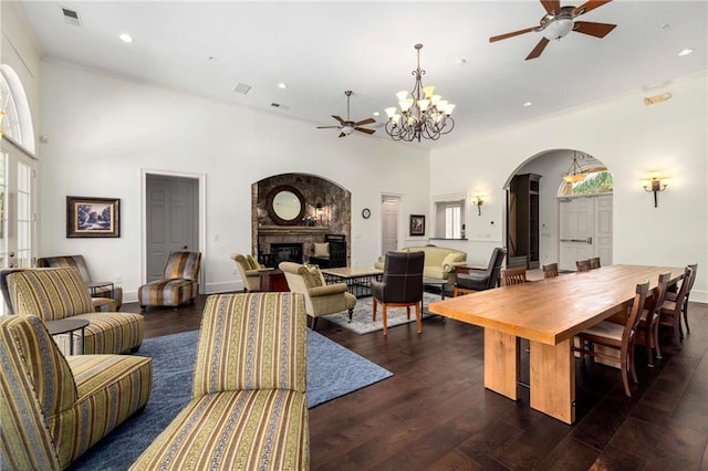 11271 Calypso Dr, Alpharetta, GA 30009 - living room featuring a ceiling fan, arched walkways, a glass covered fireplace, recessed lighting, and dark wood-type flooring