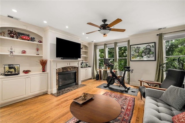 11271 Calypso Dr, Alpharetta, GA 30009 - living room with a ceiling fan, healthy amount of natural light, a premium fireplace, light wood finished floors, and recessed lighting