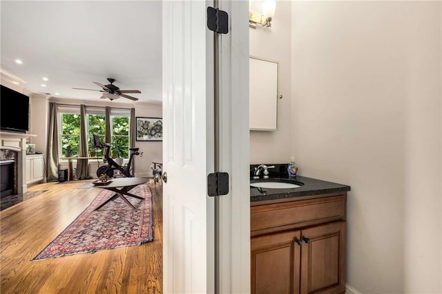 11271 Calypso Dr, Alpharetta, GA 30009 - bar area with wood finished floors, a premium fireplace, ceiling fan, recessed lighting, and crown molding