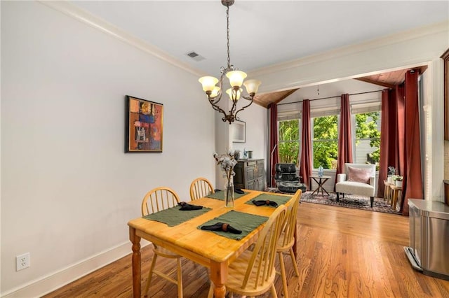 11271 Calypso Dr, Alpharetta, GA 30009 - dining space with a chandelier, wood finished floors, lofted ceiling, and crown molding