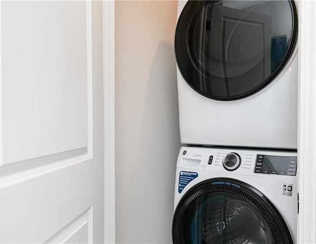 laundry room with laundry area and stacked washer / dryer