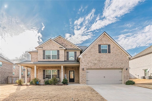 879 Tranquil Way, Hampton, GA 30228 - view of front of property with a garage, driveway, brick siding, and a porch