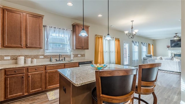 879 Tranquil Way, Hampton, GA 30228 - kitchen with wood finished floors, brown cabinetry, backsplash, stainless steel dishwasher, and recessed lighting