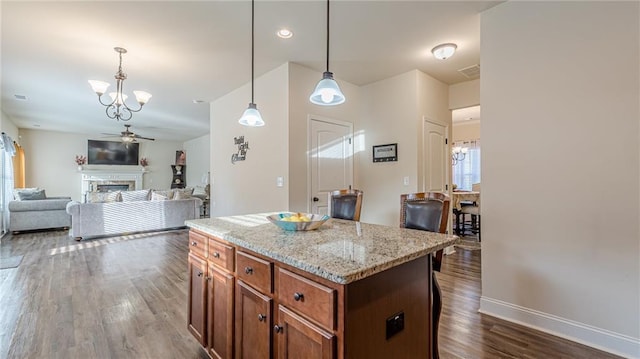 879 Tranquil Way, Hampton, GA 30228 - kitchen featuring a chandelier, dark wood-style floors, pendant lighting, a kitchen island, and a ceiling fan