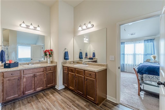 879 Tranquil Way, Hampton, GA 30228 - ensuite bathroom with two vanities and wood finished floors