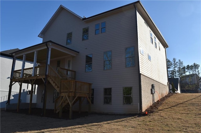 rear view of property featuring a wooden deck