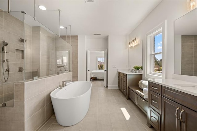 bathroom featuring tile patterned floors, vanity, and independent shower and bath