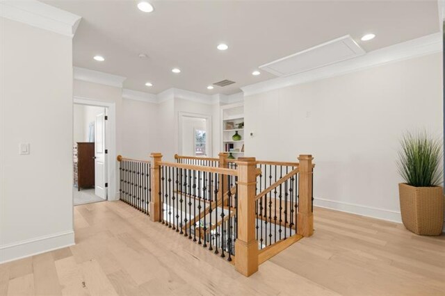 living room with light wood-type flooring and ornamental molding