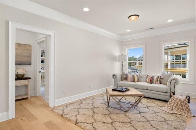 living room with hardwood / wood-style flooring and ornamental molding