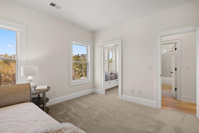 bedroom featuring light colored carpet